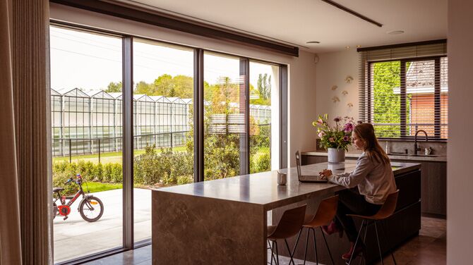 Interior view of private home, with wide sliding doors looking out on garden.