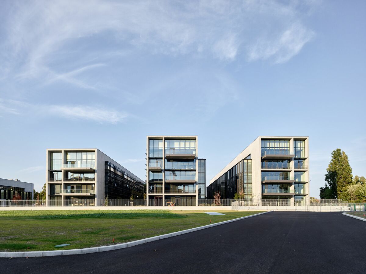 Three office buildings located in the green Jardins du Lou business complex in Lyon, France.